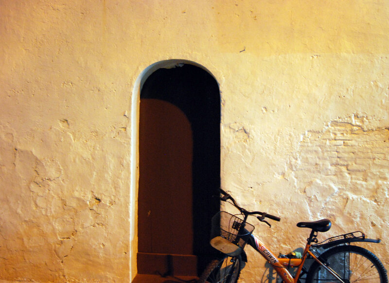 Orange Bicycle by Doorway