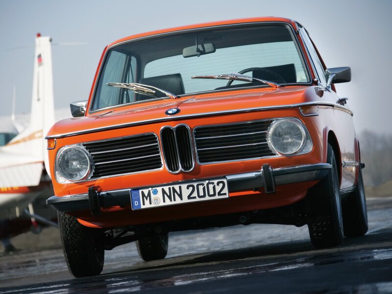 Orange BMW 2002 on wet tarmac