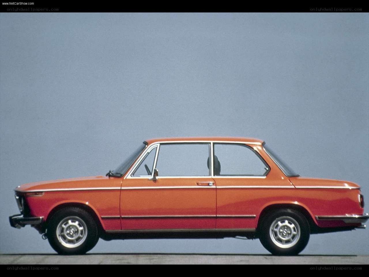 Orange BMW 2002 sedan