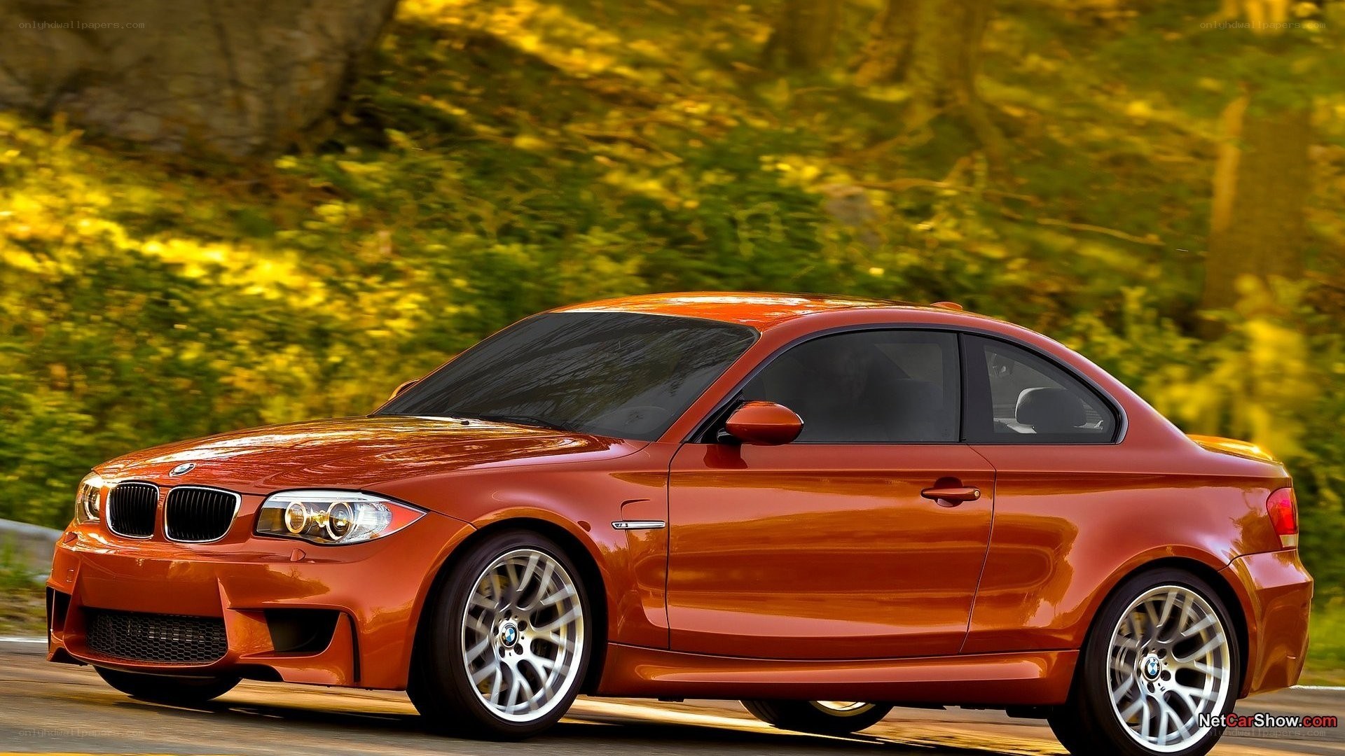 orange BMW coupe in motion