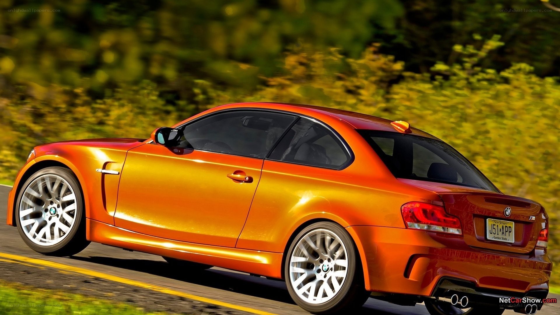 orange bmw coupe in motion