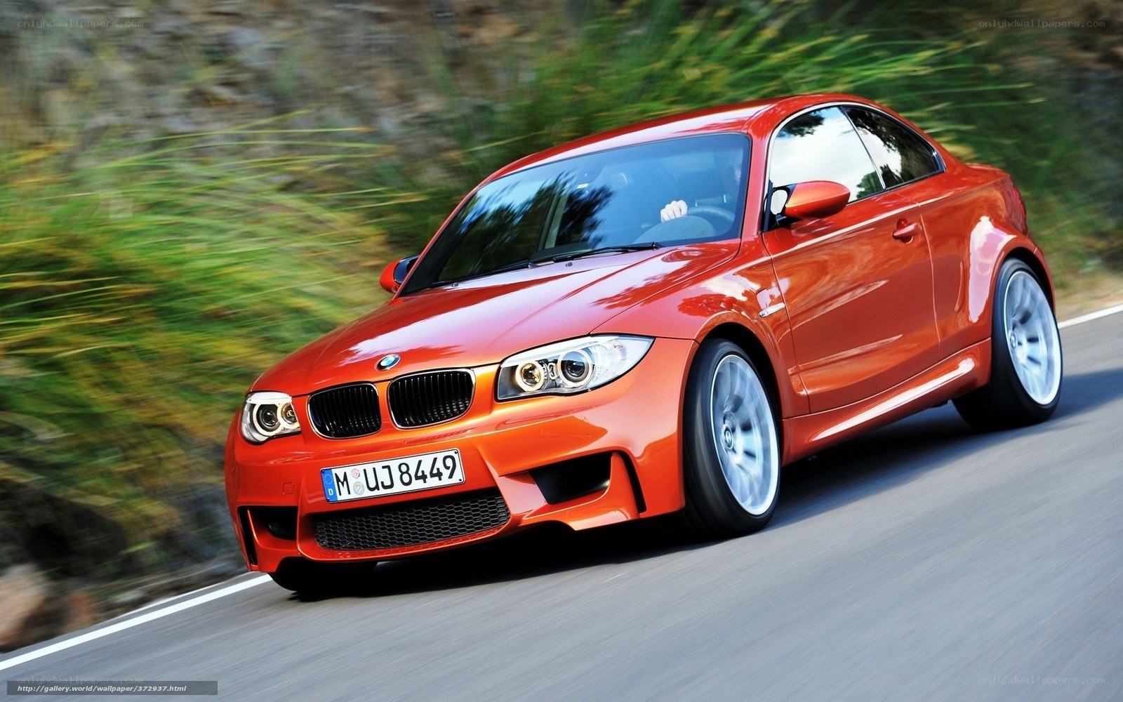 orange BMW coupe in motion