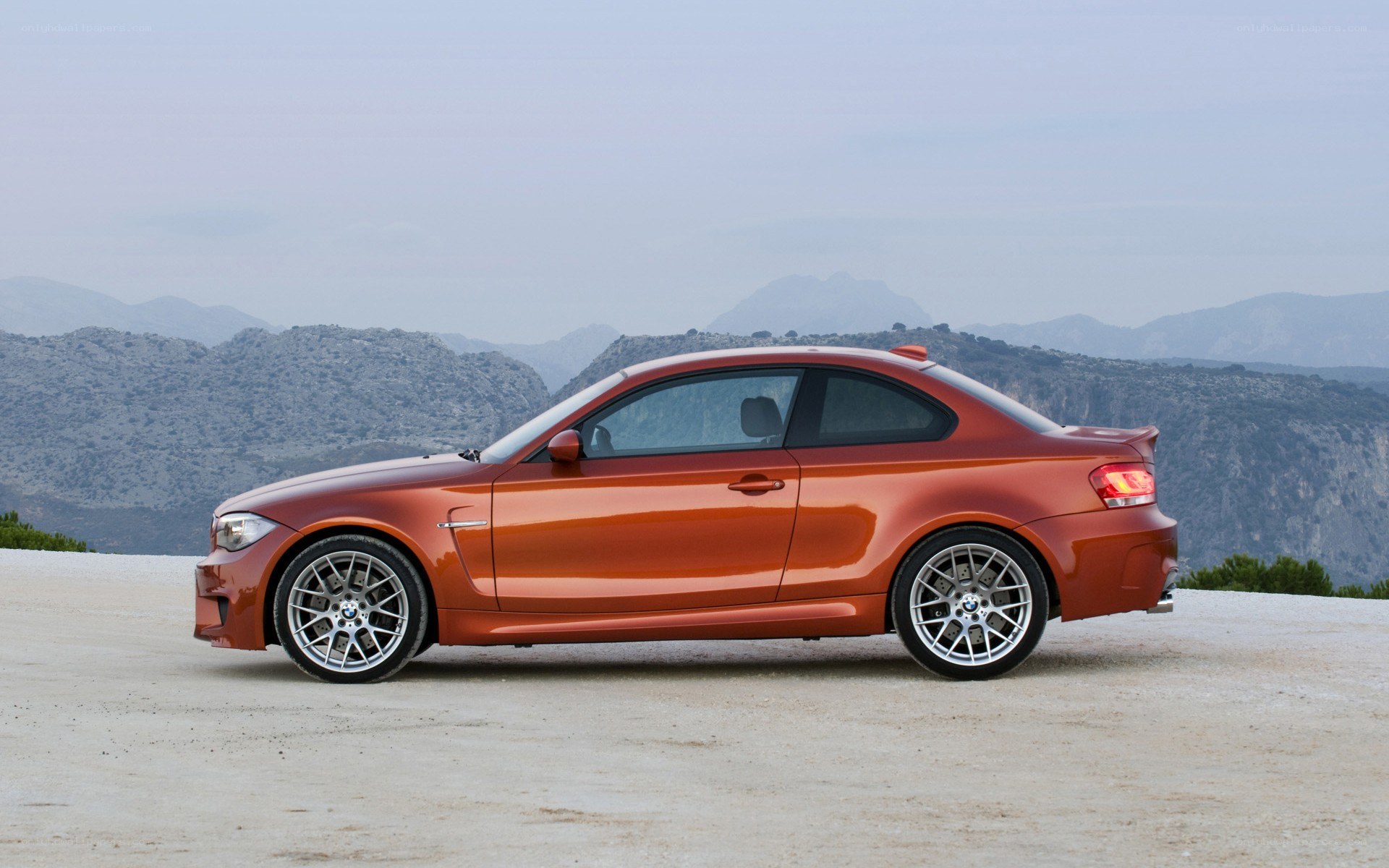 Orange BMW coupe on mountain road
