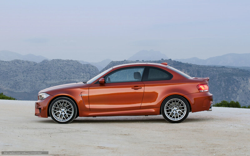 orange bmw coupe on mountain road