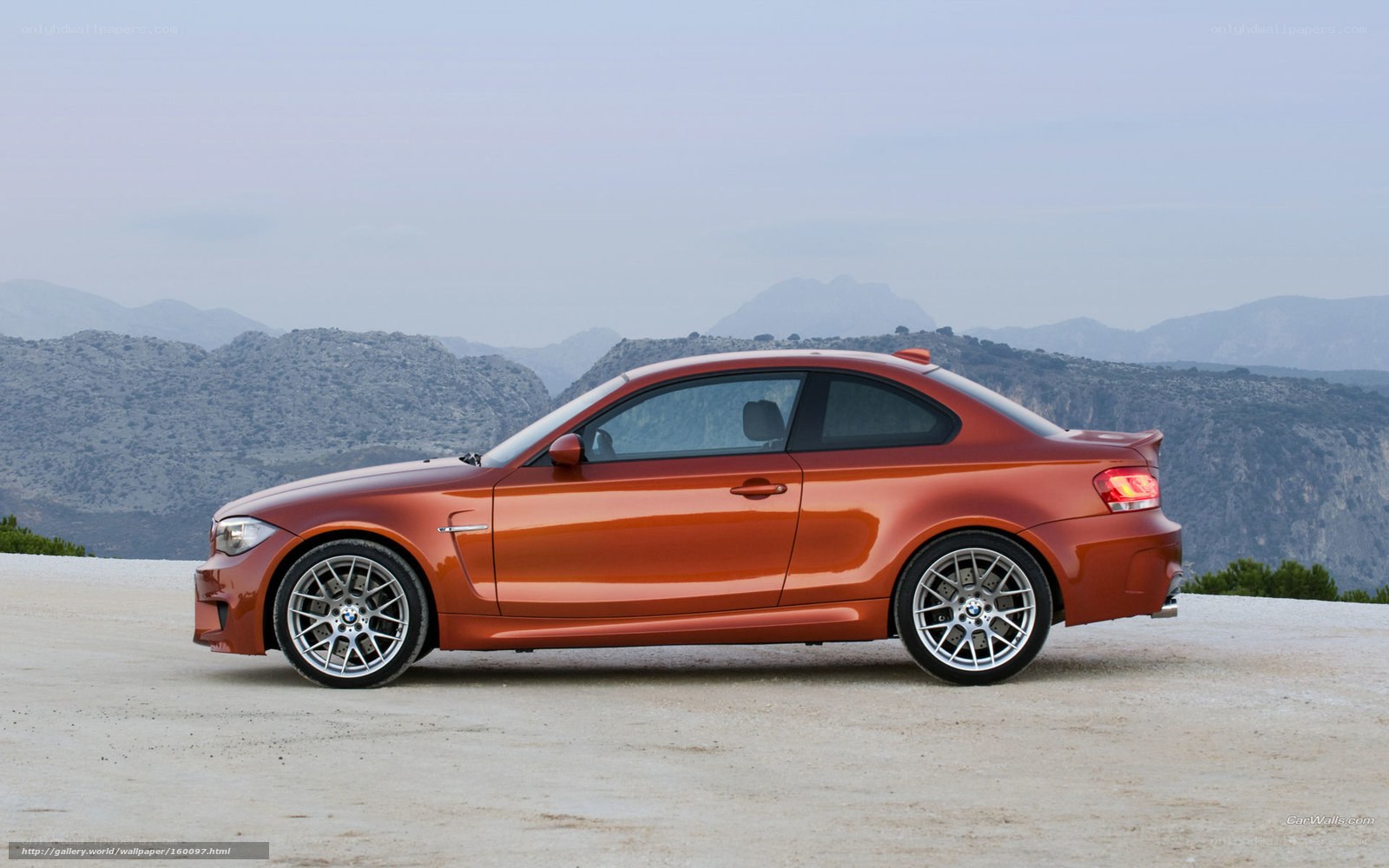 orange bmw coupe on mountain road