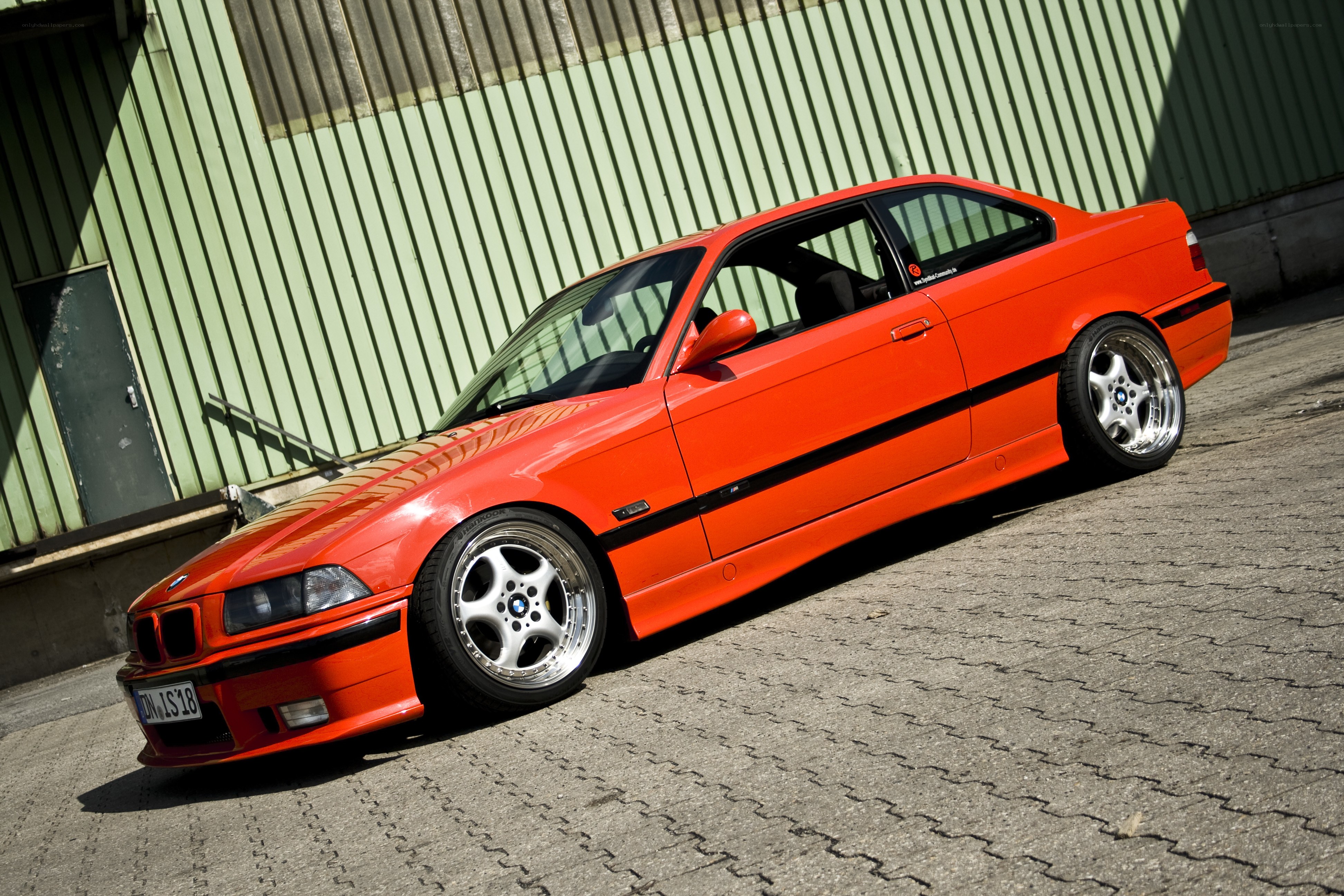 orange BMW coupe parked