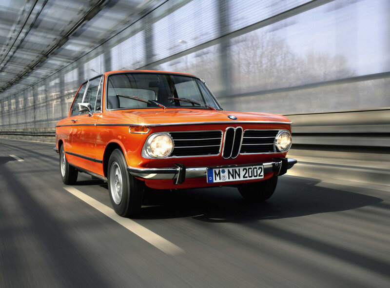 Orange BMW driving on highway