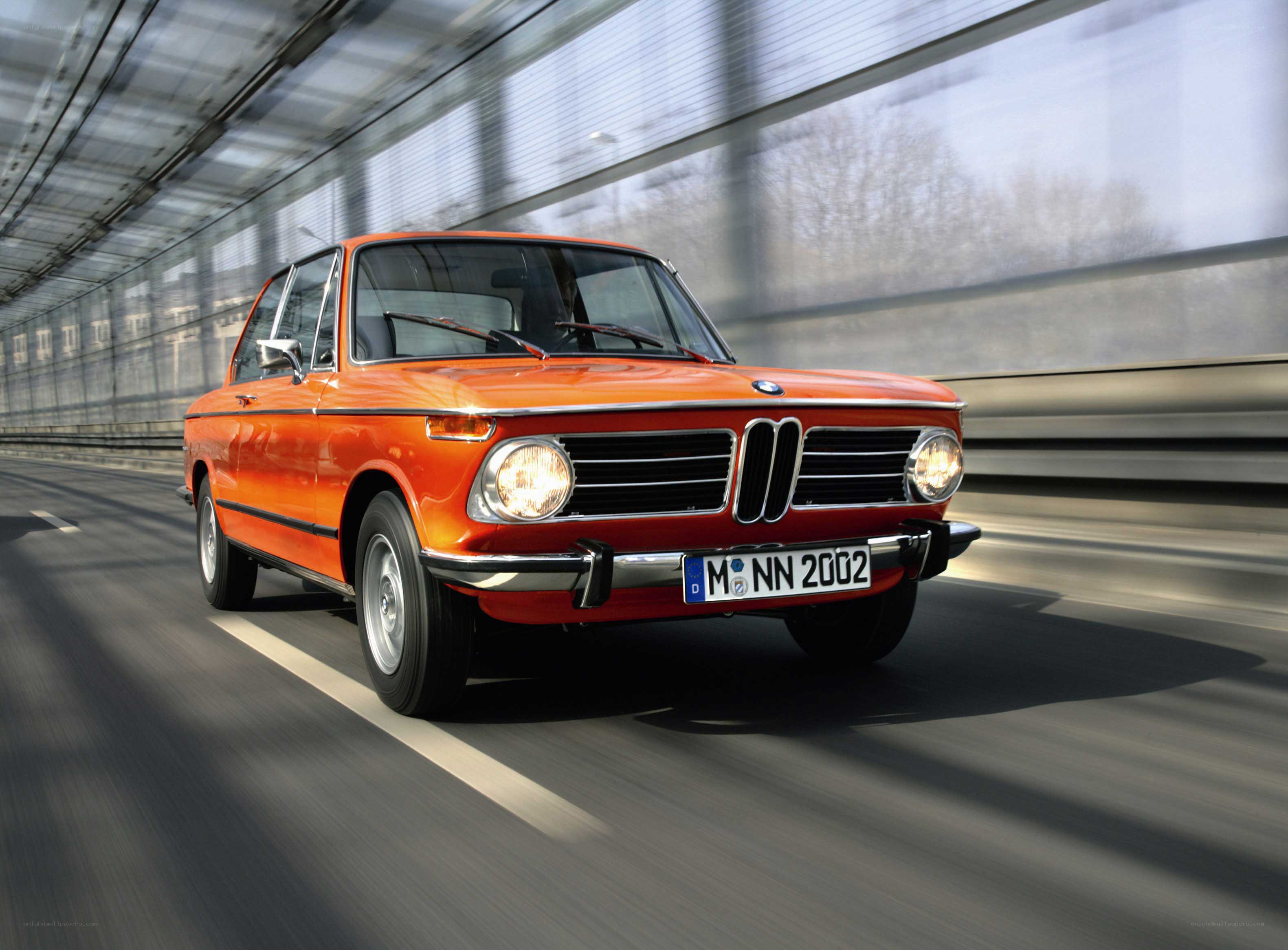 Orange BMW driving on highway