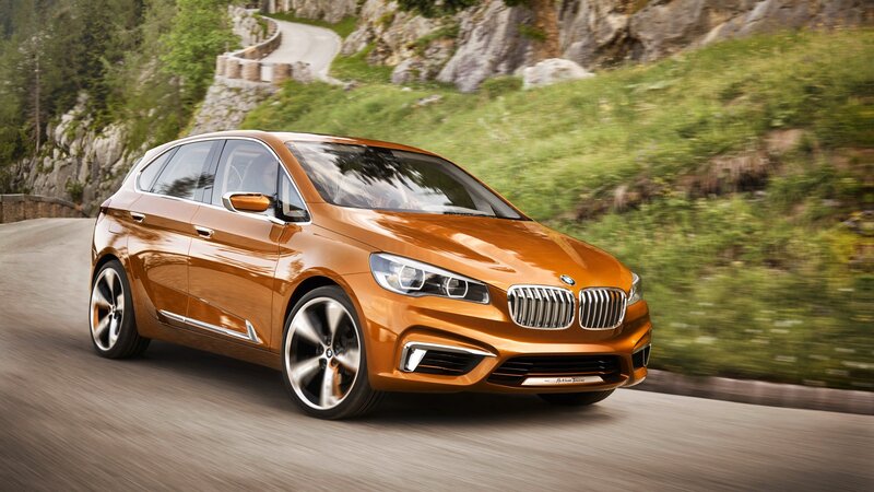 Orange BMW driving on mountain road