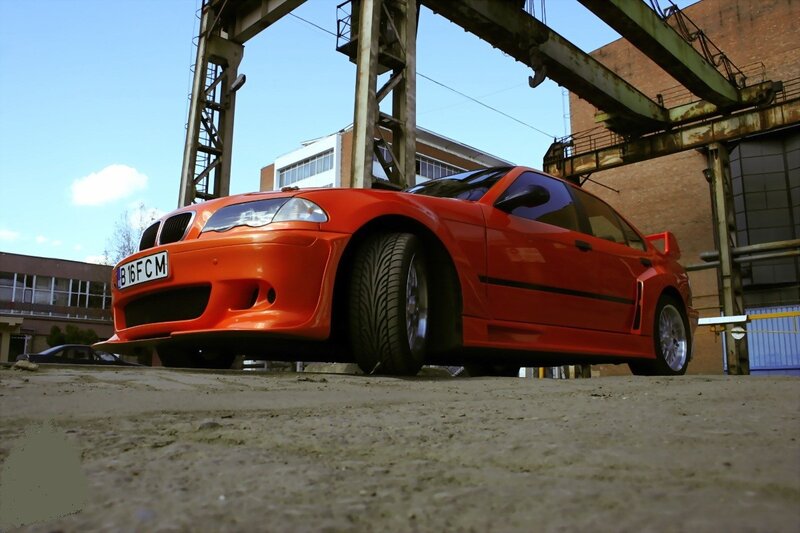 Orange BMW in industrial setting