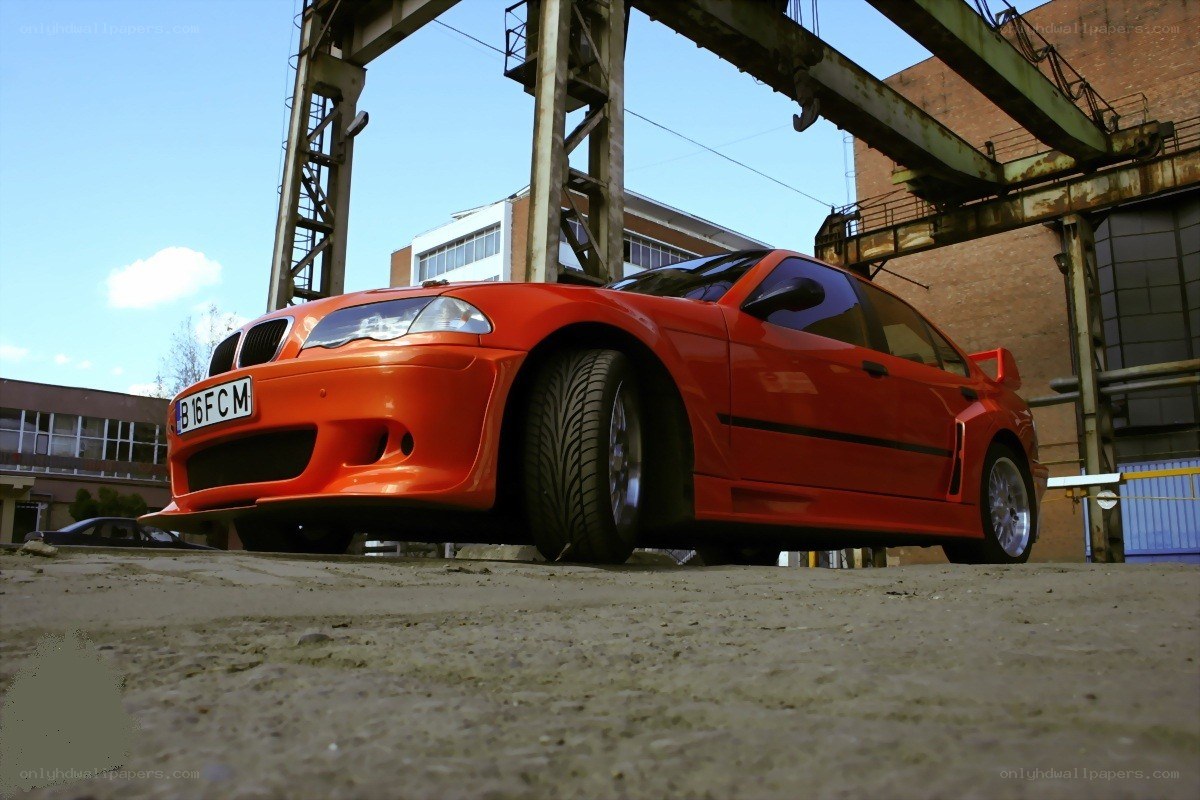 Orange BMW in industrial setting