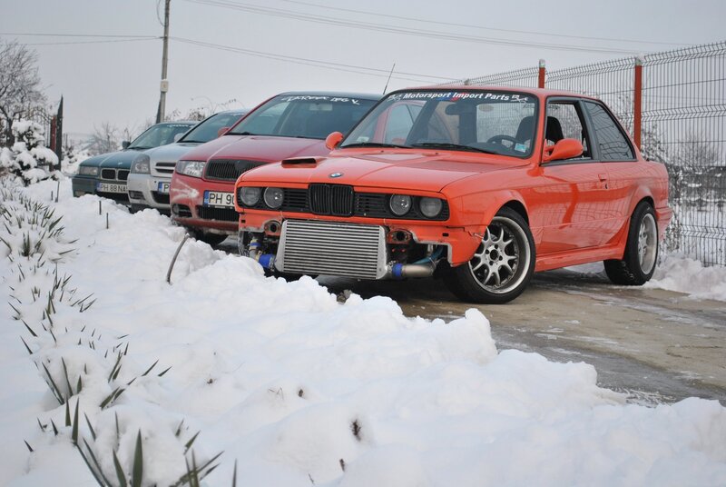 Orange BMW in snowy parking