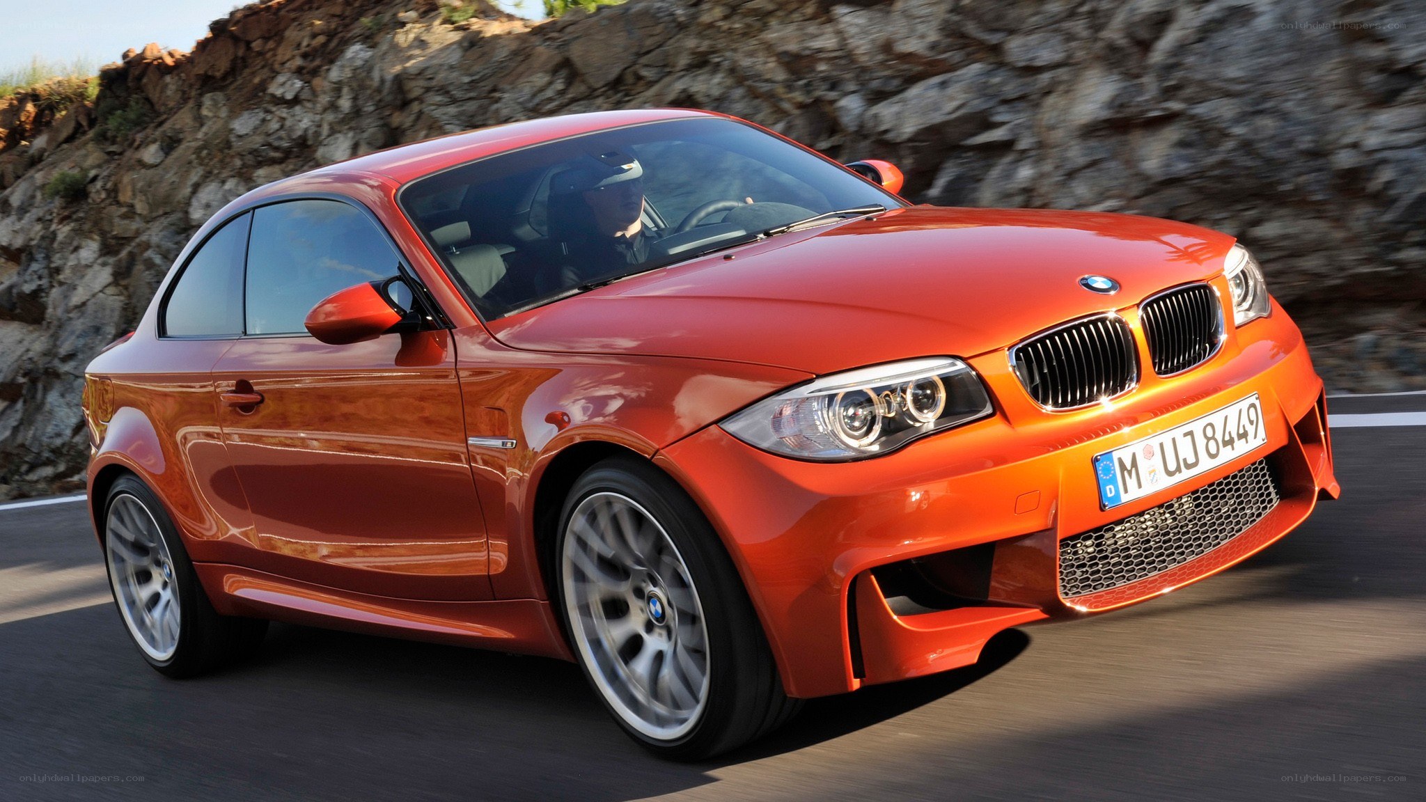 Orange BMW M135i in motion