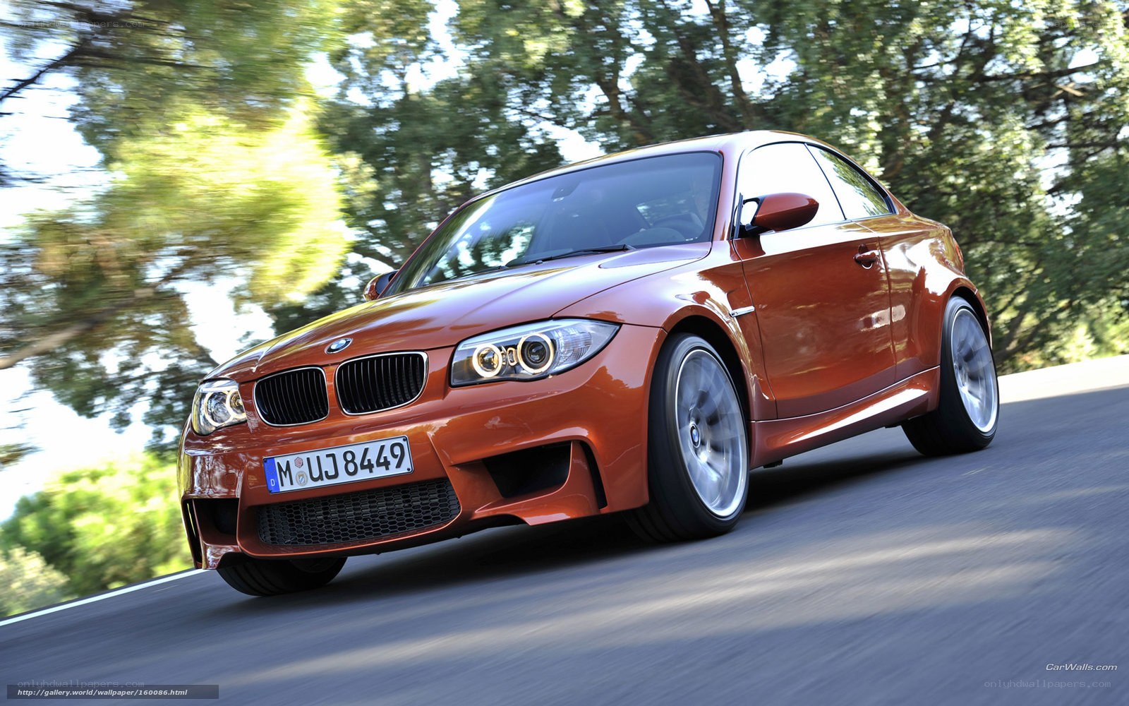 Orange BMW M135i in motion