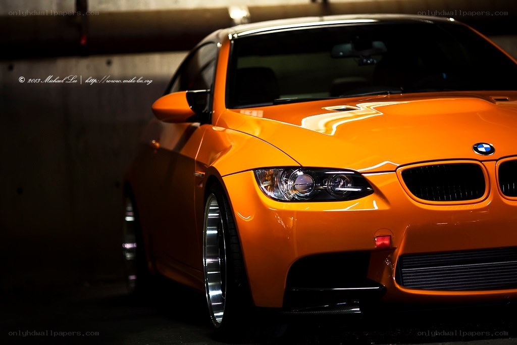 Orange BMW M3 in a garage