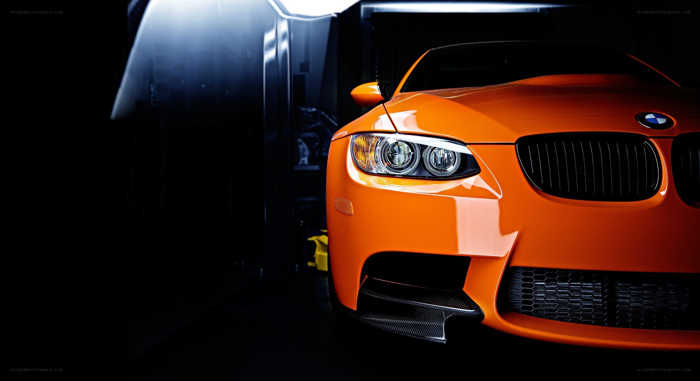 orange bmw m3 in garage