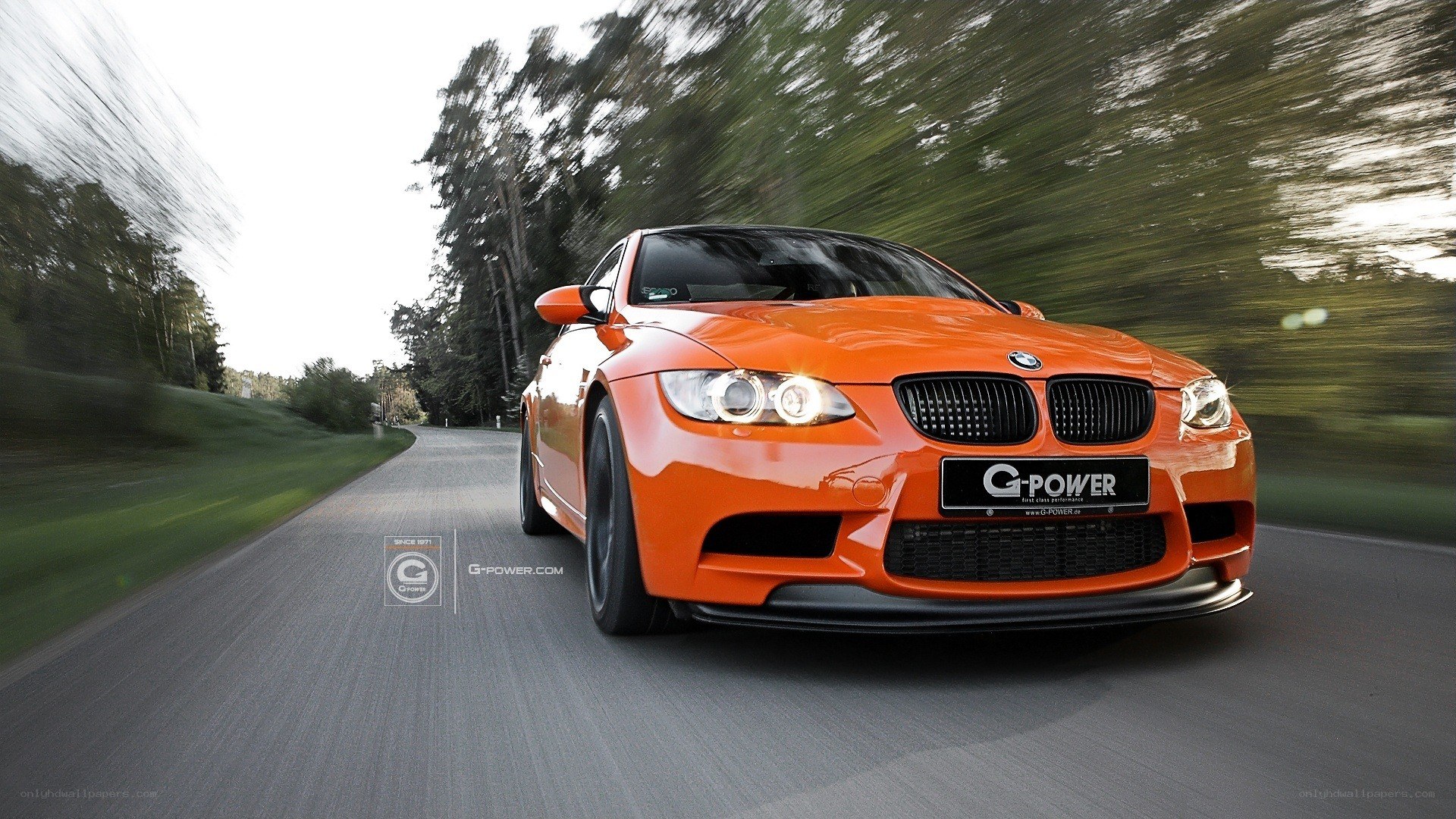 orange bmw m3 in motion