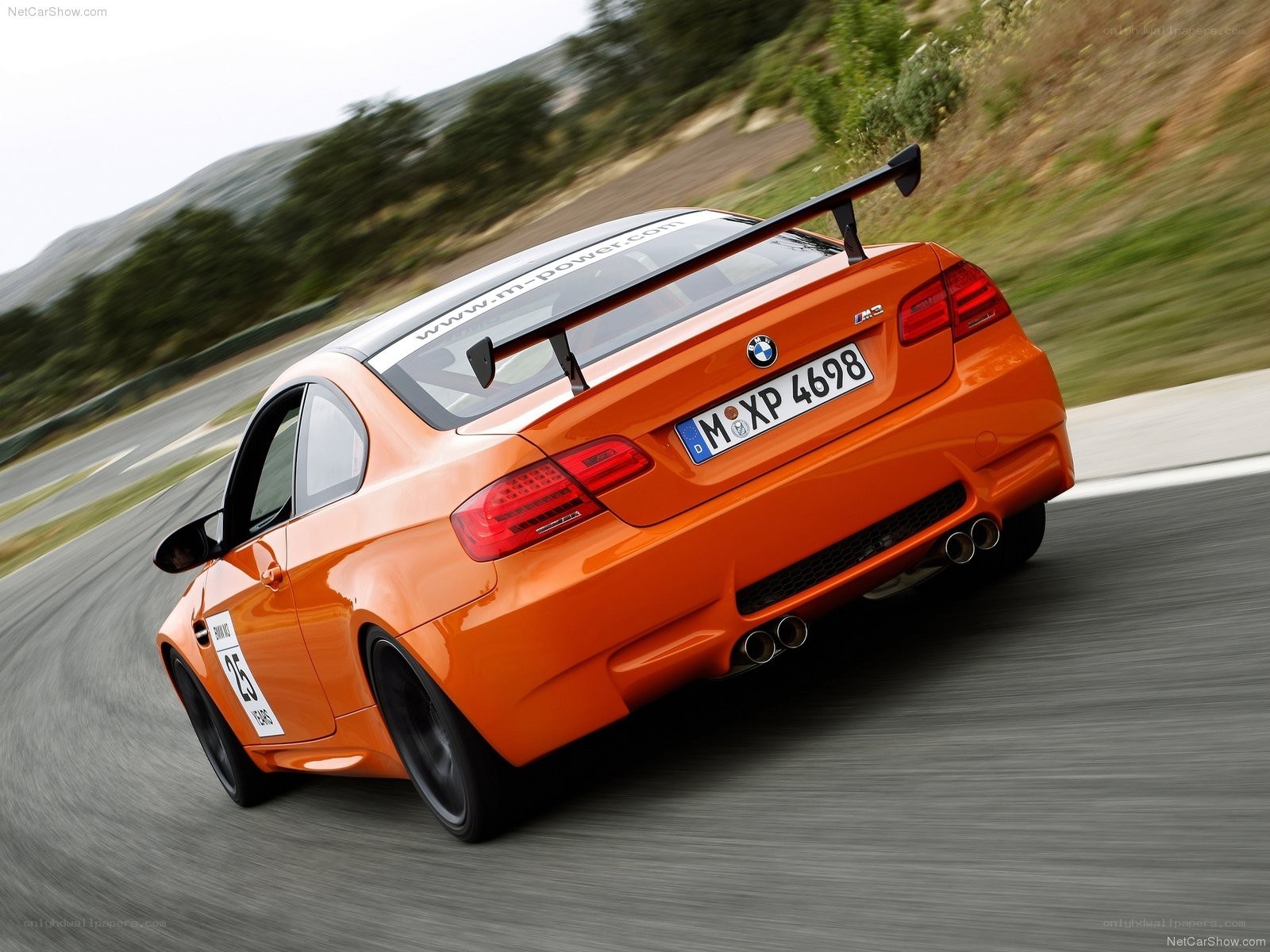 orange BMW M3 on a racetrack