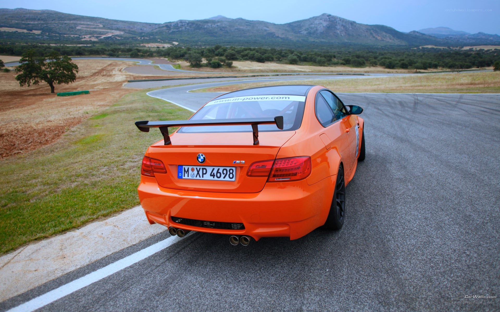 Orange BMW M3 on a racetrack