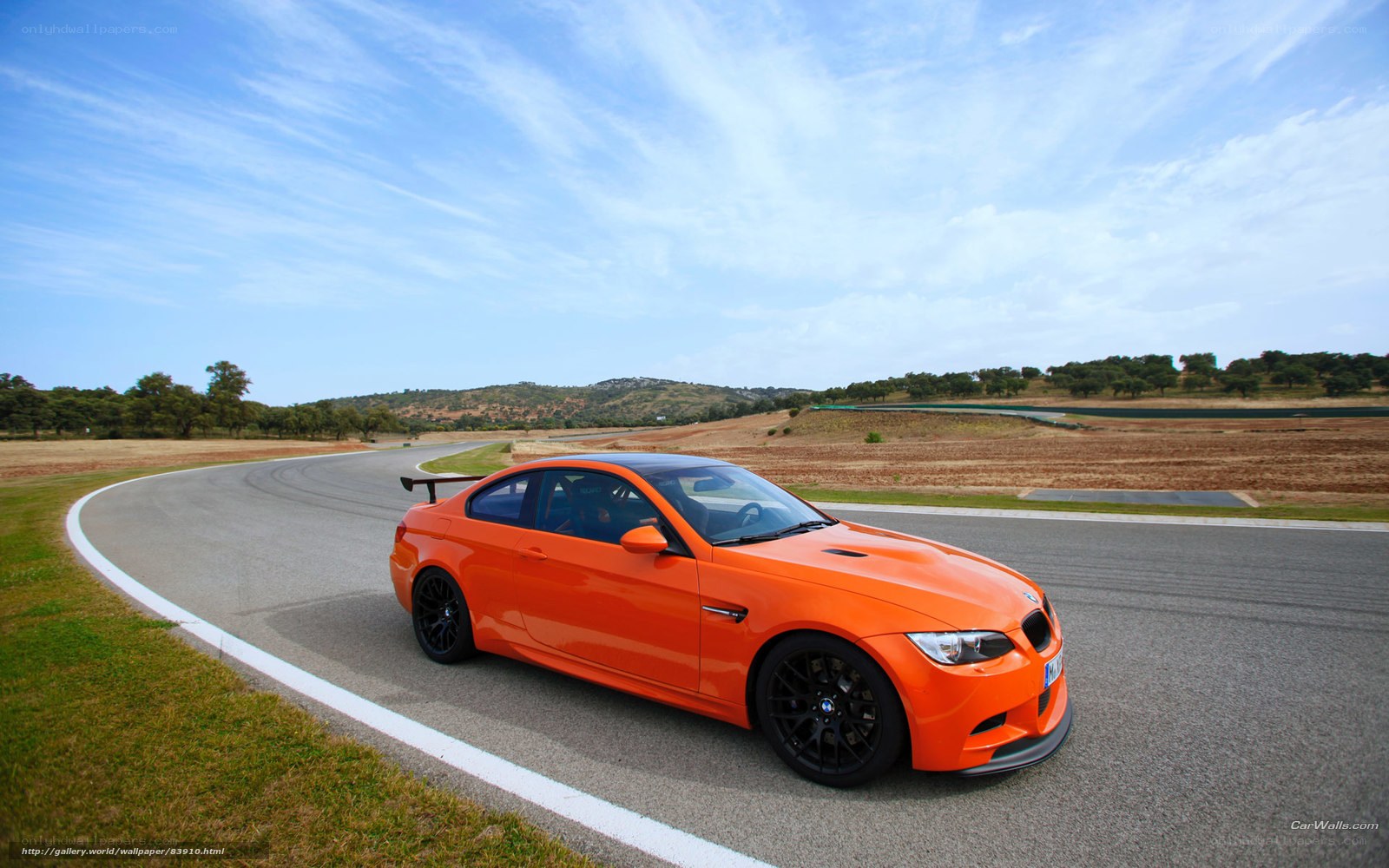 Orange BMW M3 on a racetrack