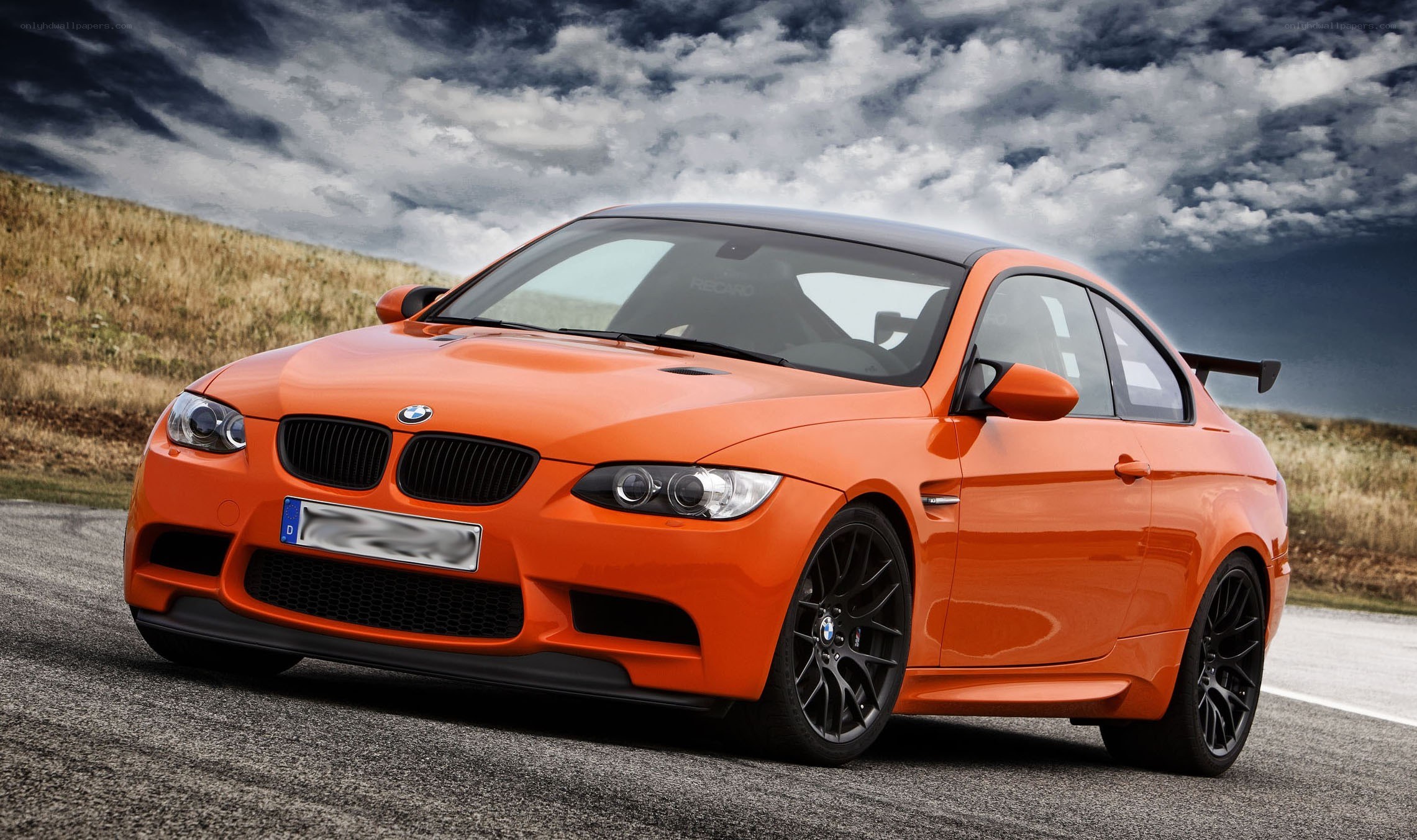 Orange BMW M3 on a road