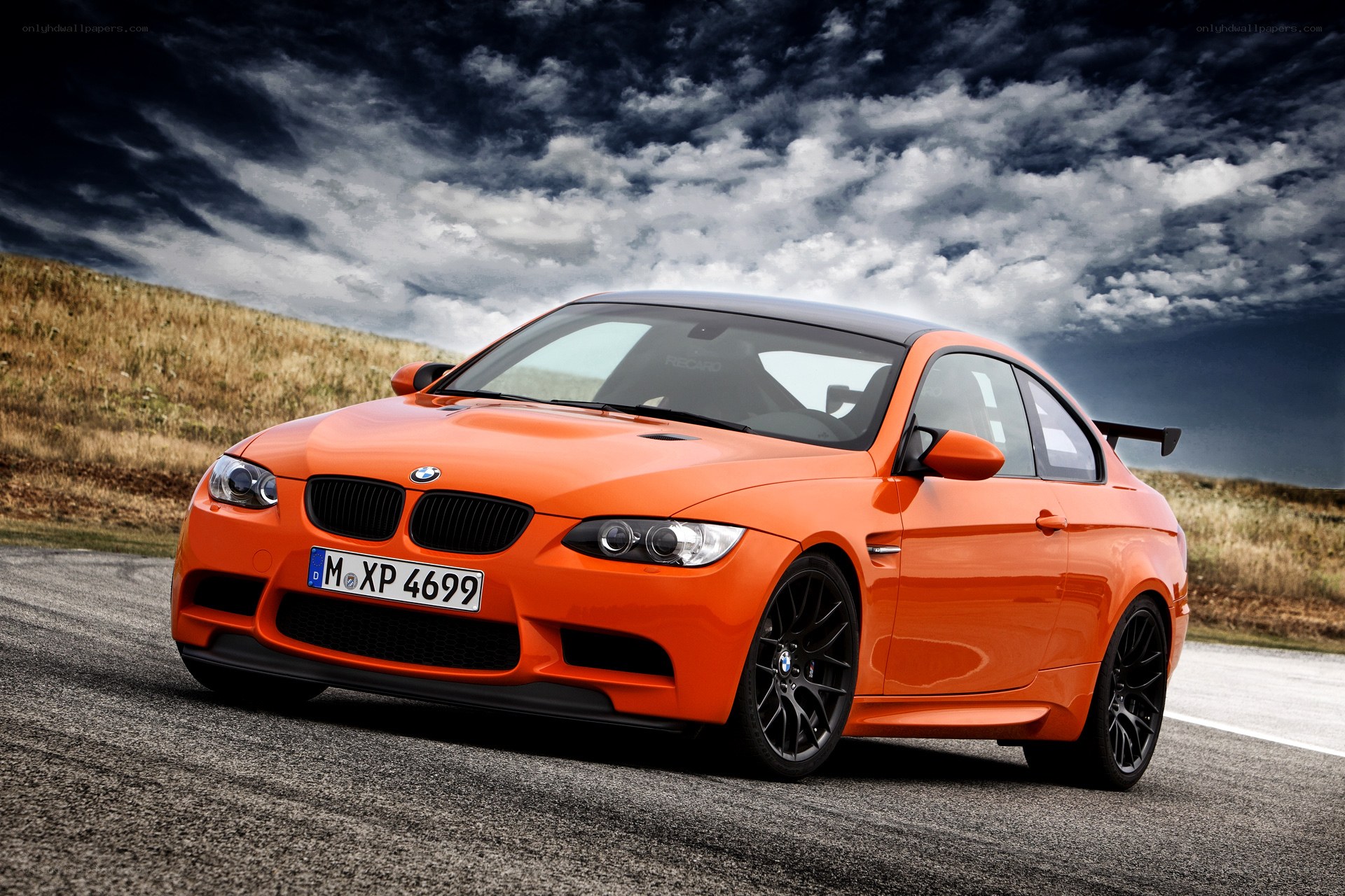 Orange BMW M3 on a road