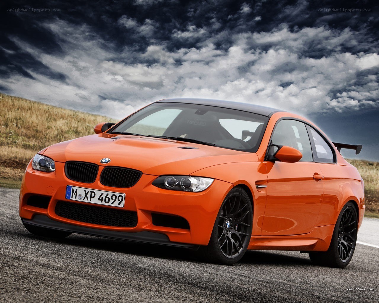 Orange BMW M3 on a road