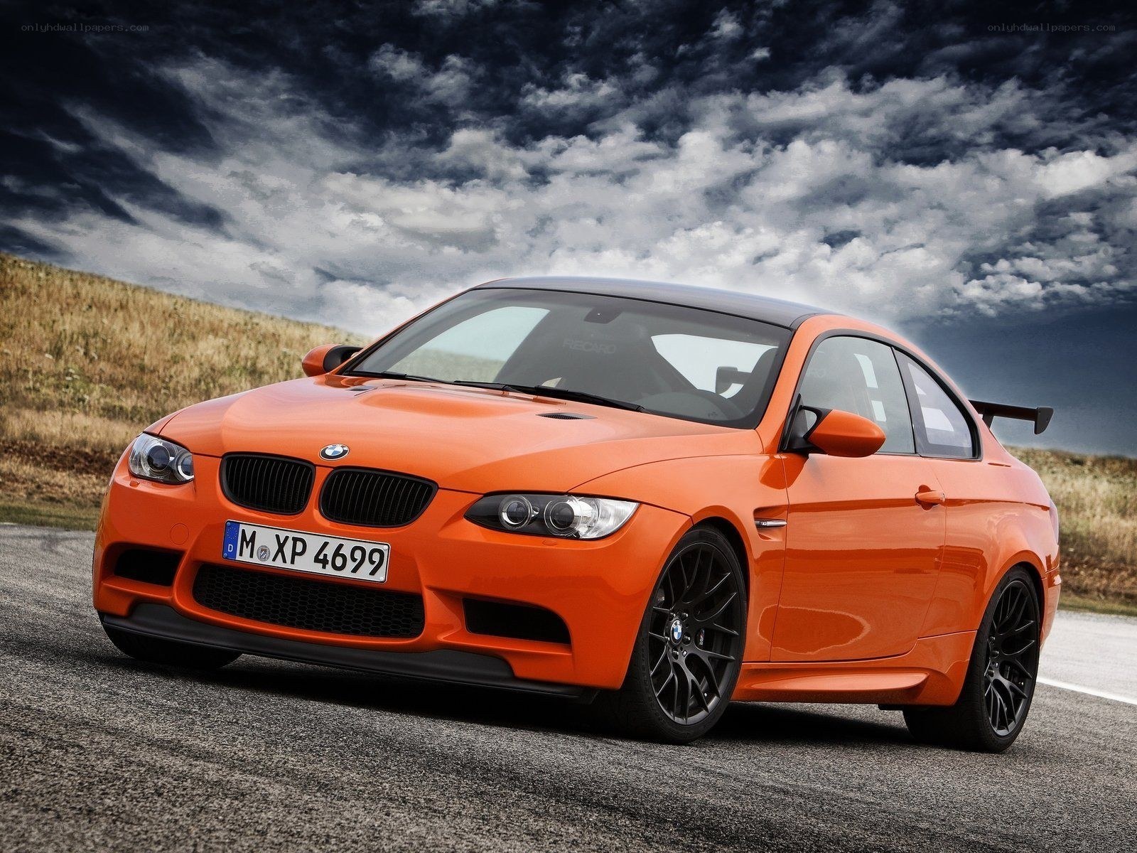 Orange BMW M3 on a road