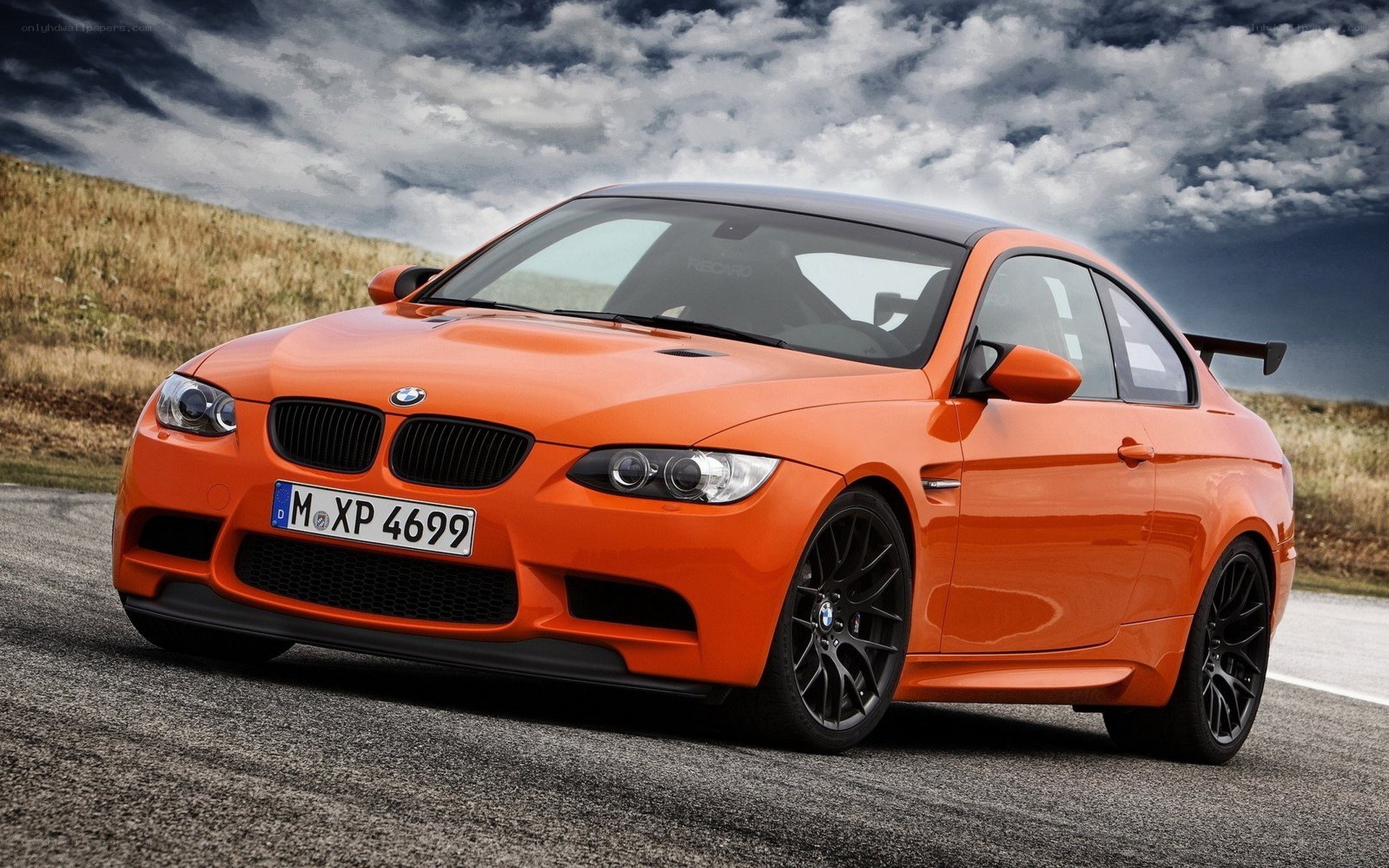 Orange BMW M3 on a road