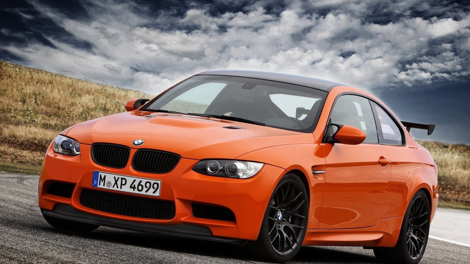 Orange BMW M3 on a road