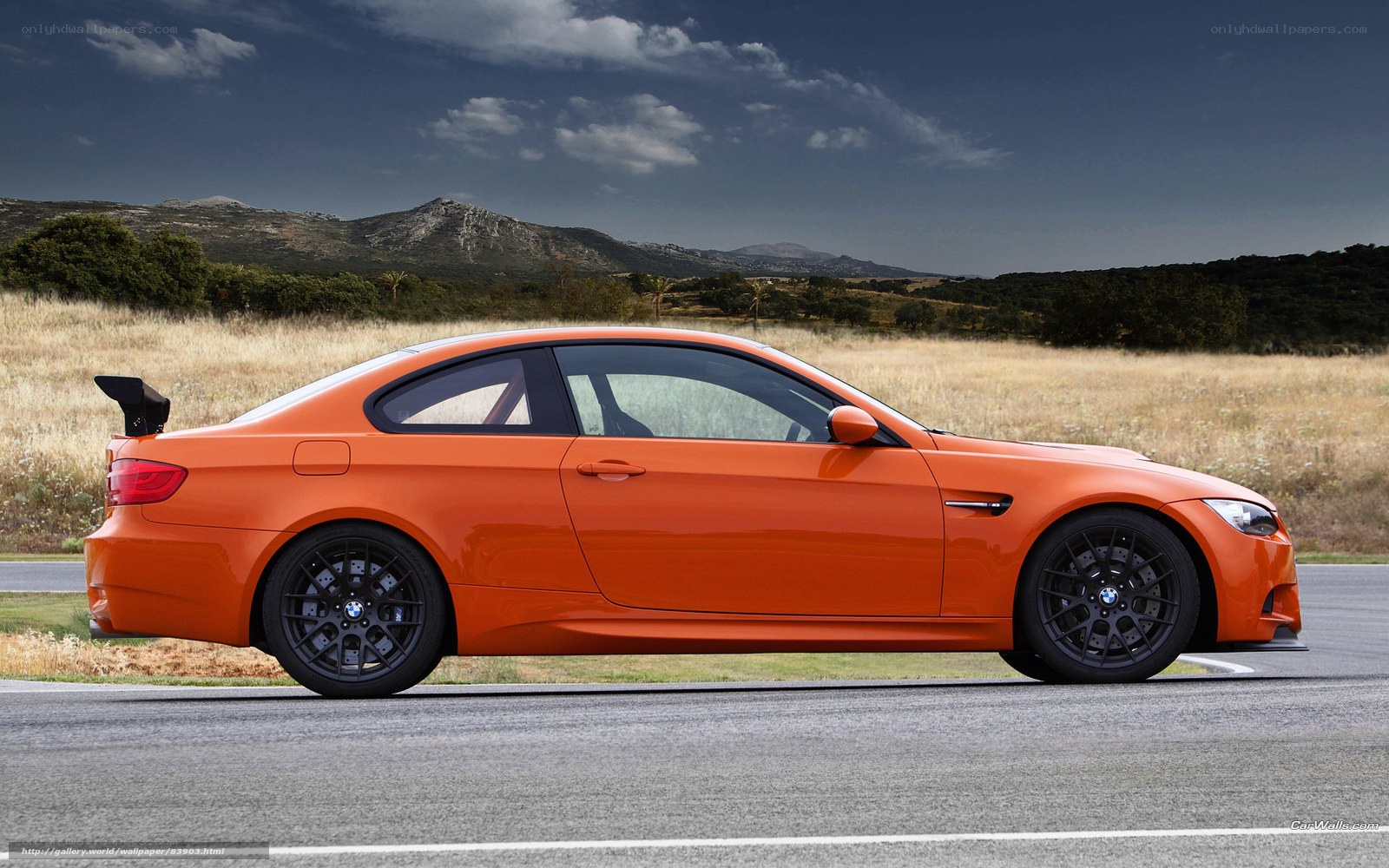 Orange BMW M3 on a track