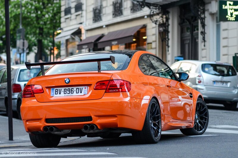 orange BMW M3 on city street
