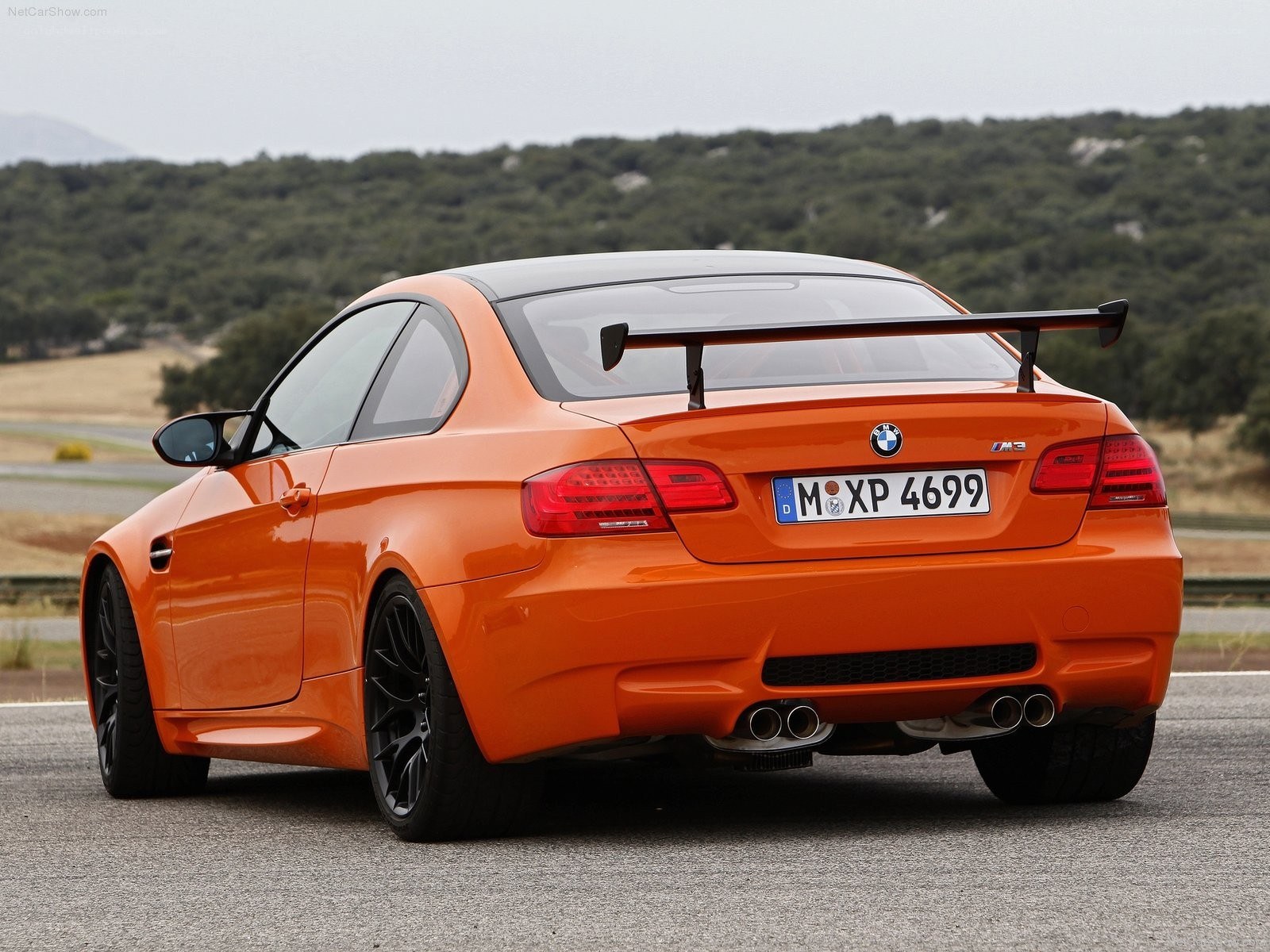 Orange BMW M3 with rear spoiler