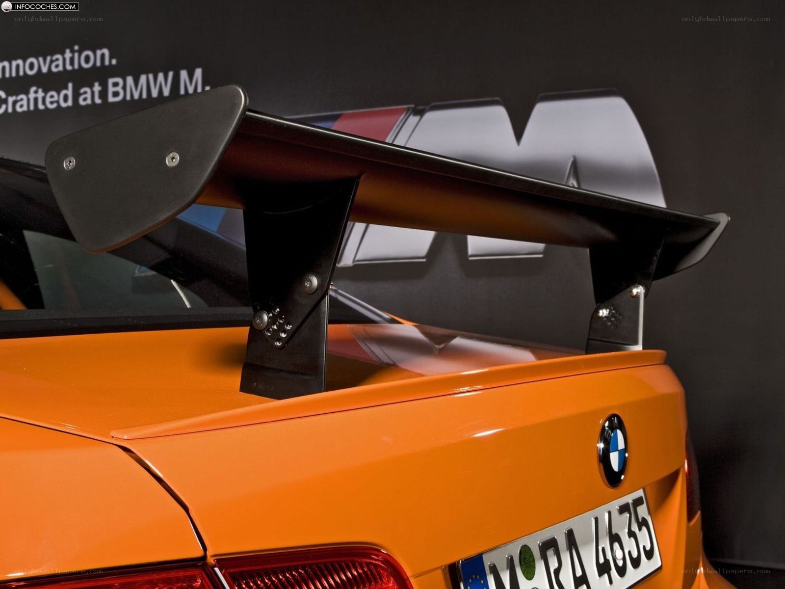 orange bmw m3 with rear wing