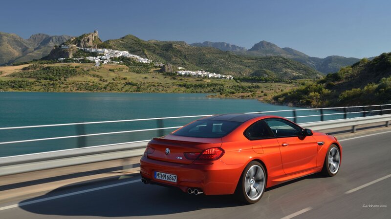 Orange BMW M6 on a scenic road