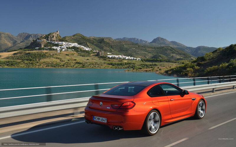 Orange BMW M6 on a scenic road