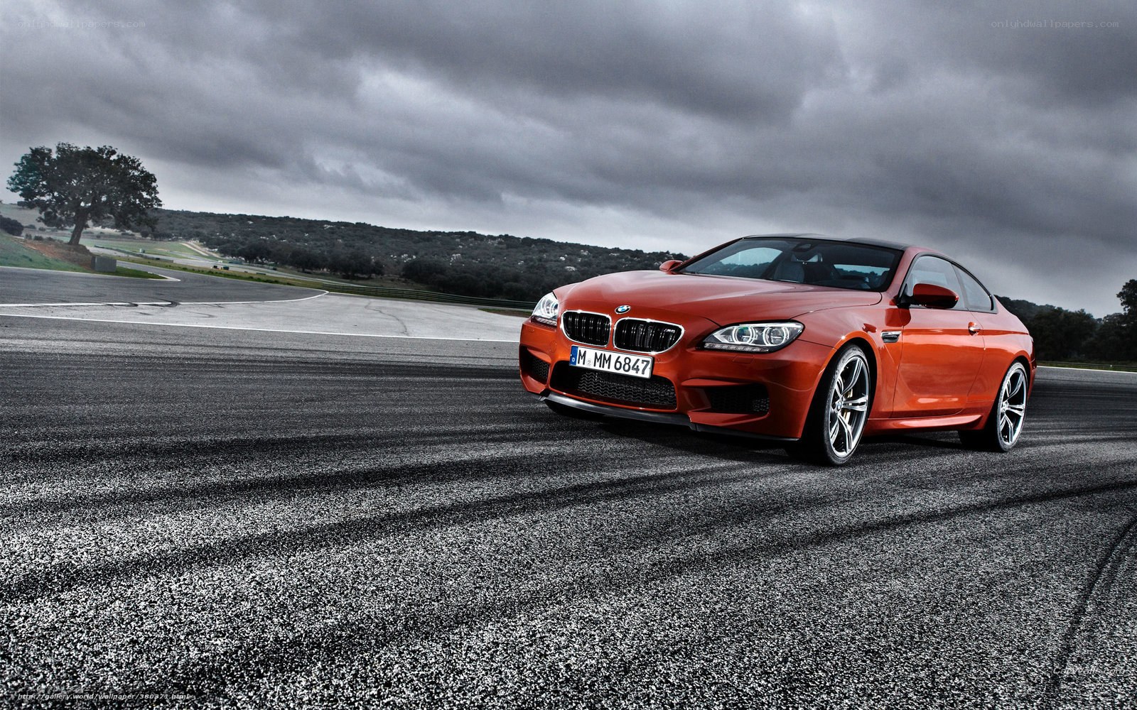 Orange BMW M6 on racetrack