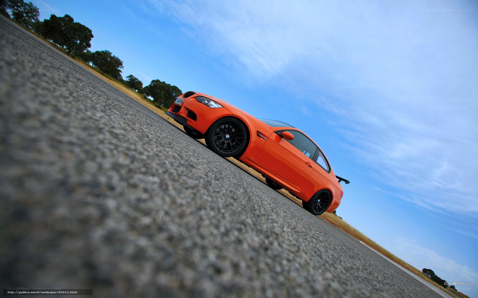 orange BMW on asphalt road