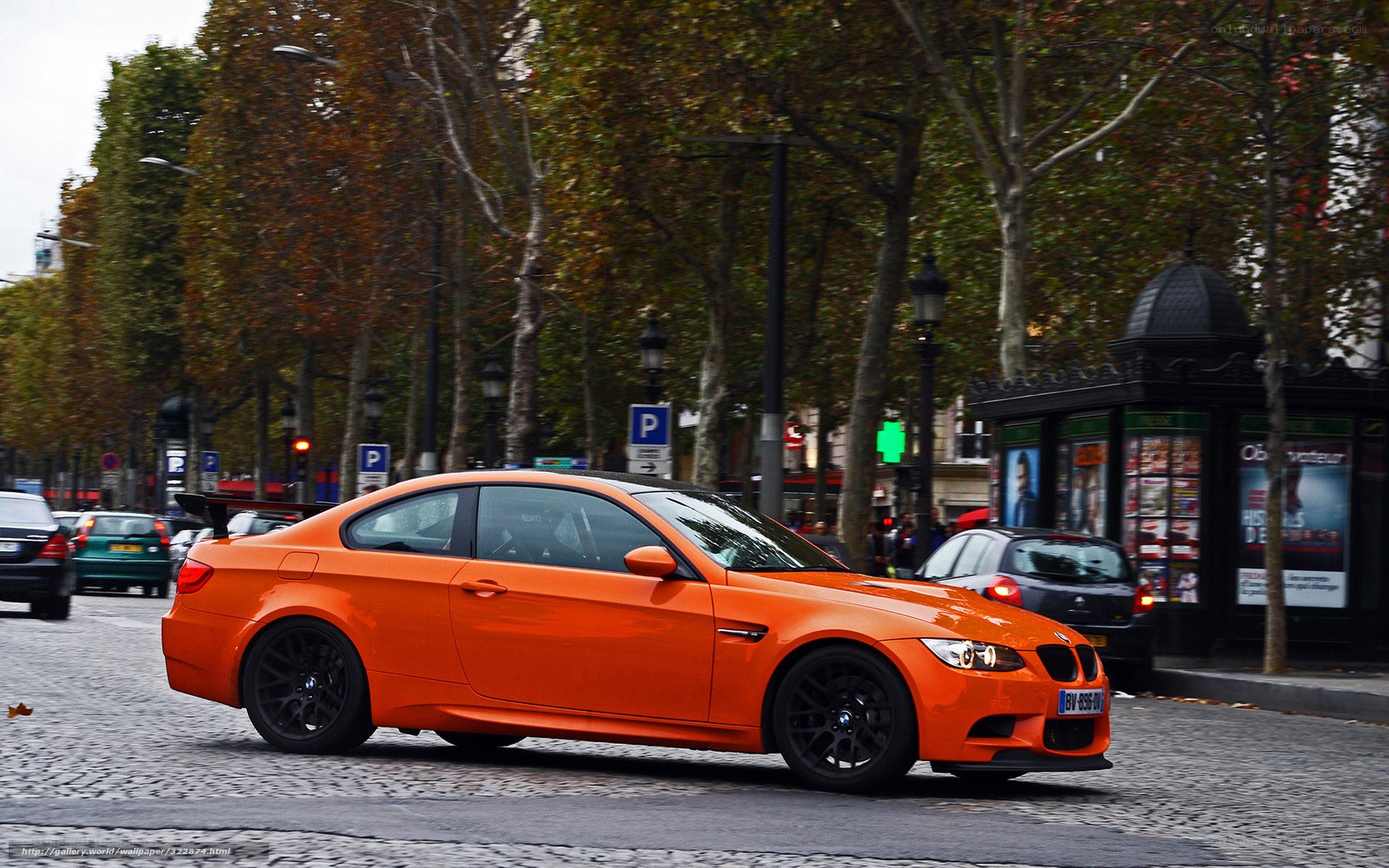 orange BMW on city street