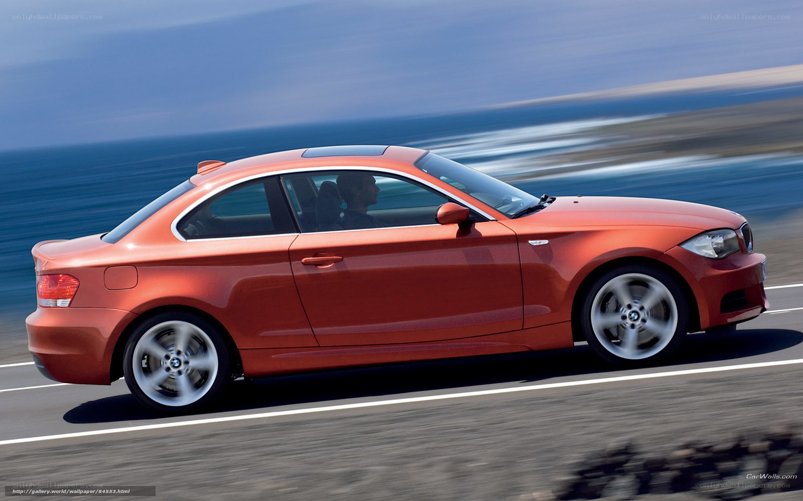 Orange BMW on coastal road