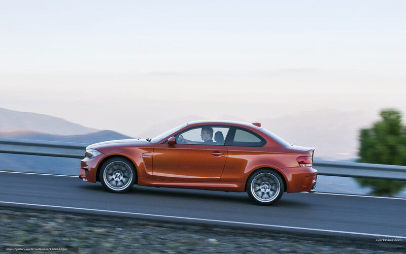 orange BMW on mountain road