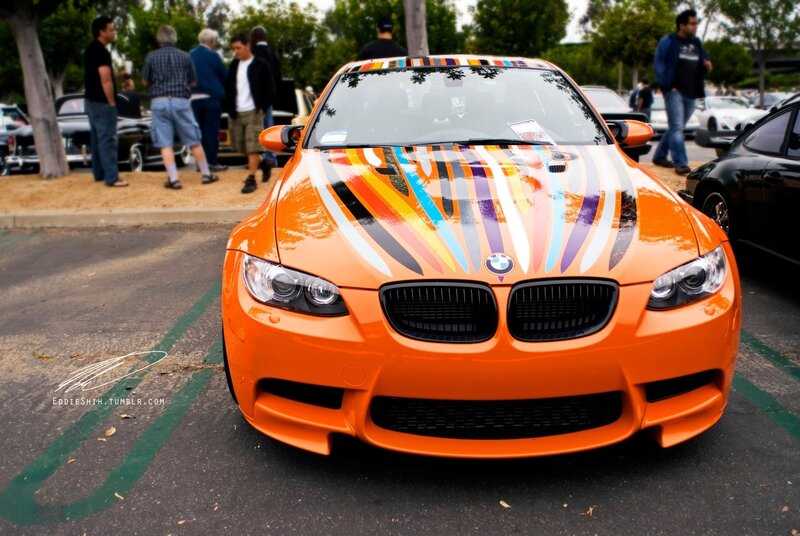 Orange BMW with colorful stripes