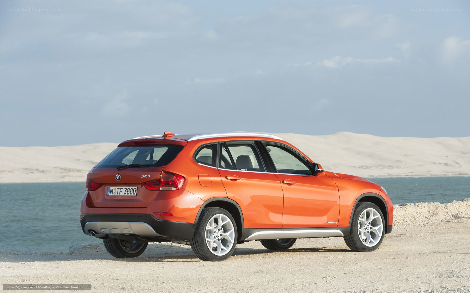 orange BMW X1 by the water
