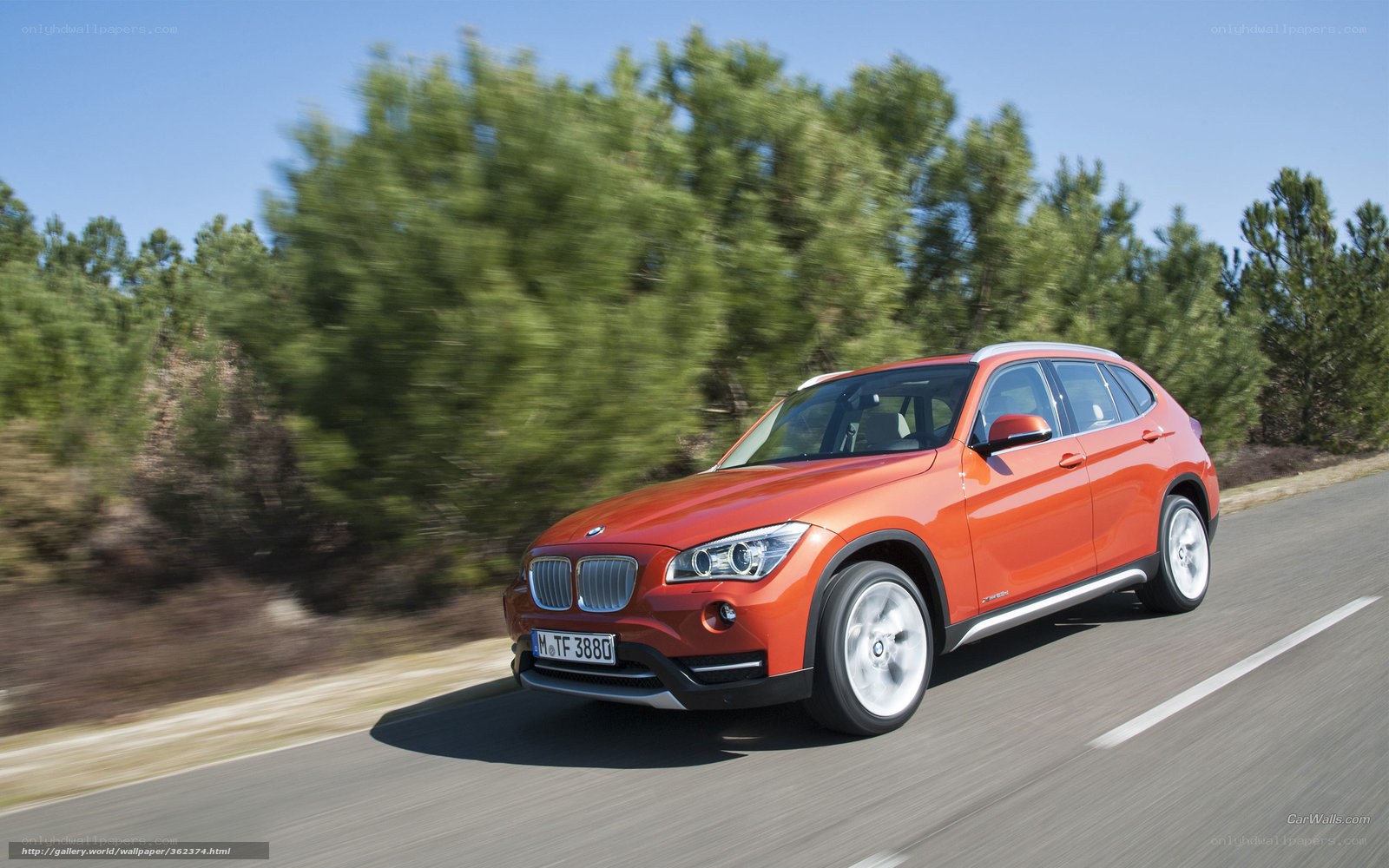 Orange BMW X1 driving on road