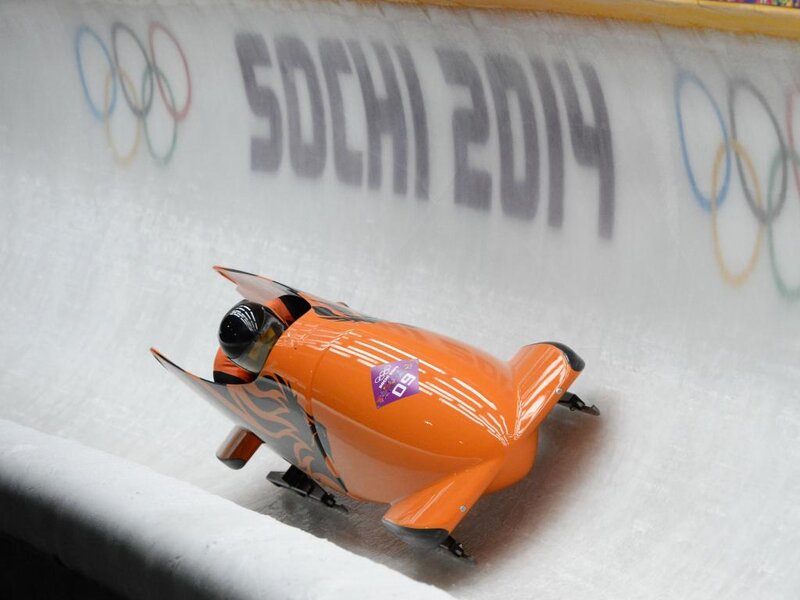 Orange Bobsled on Ice — Competitive, Photograph, Olympic Rings