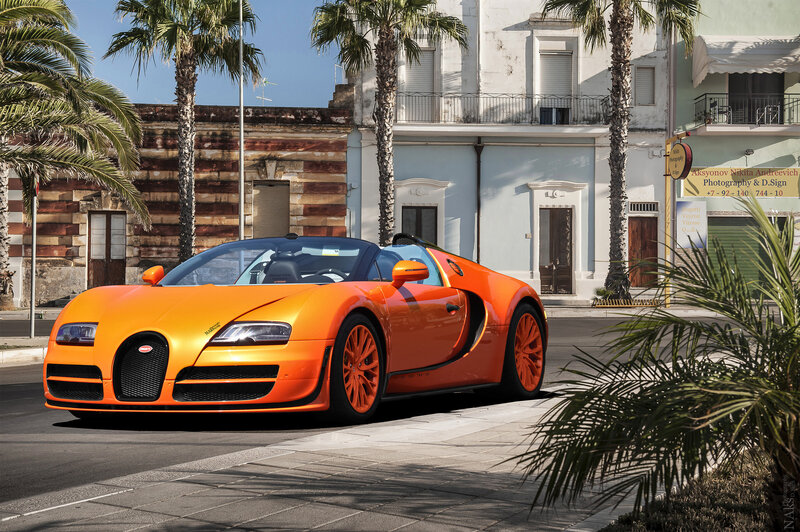 Orange Bugatti Veyron on a sunny street