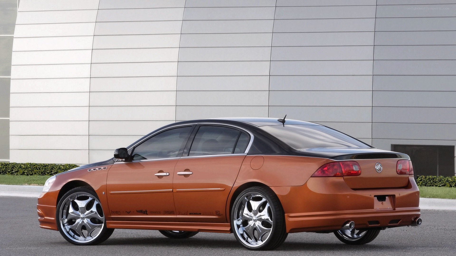 orange Buick sedan with custom wheels