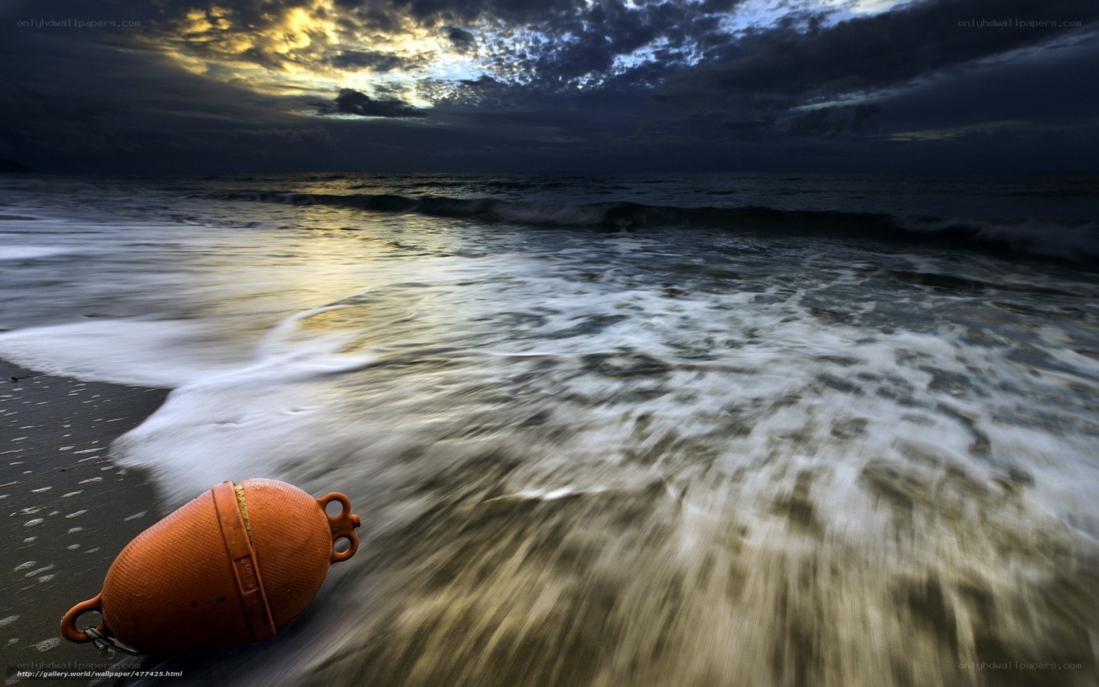 orange buoy on beach at dusk