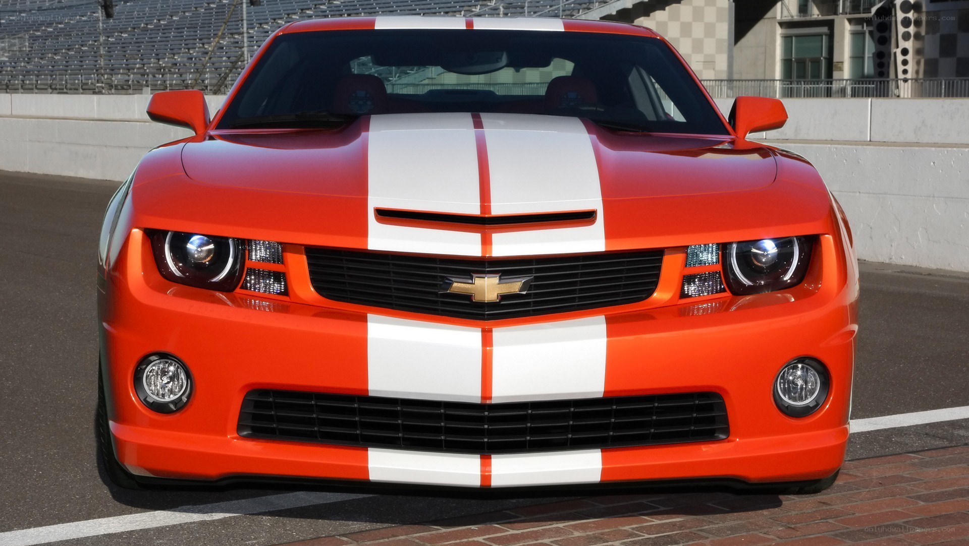 Orange Camaro with racing stripes