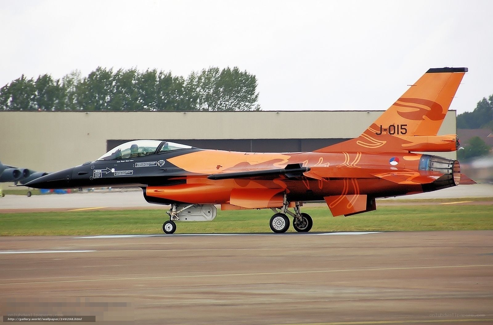 orange camo fighter jet on runway